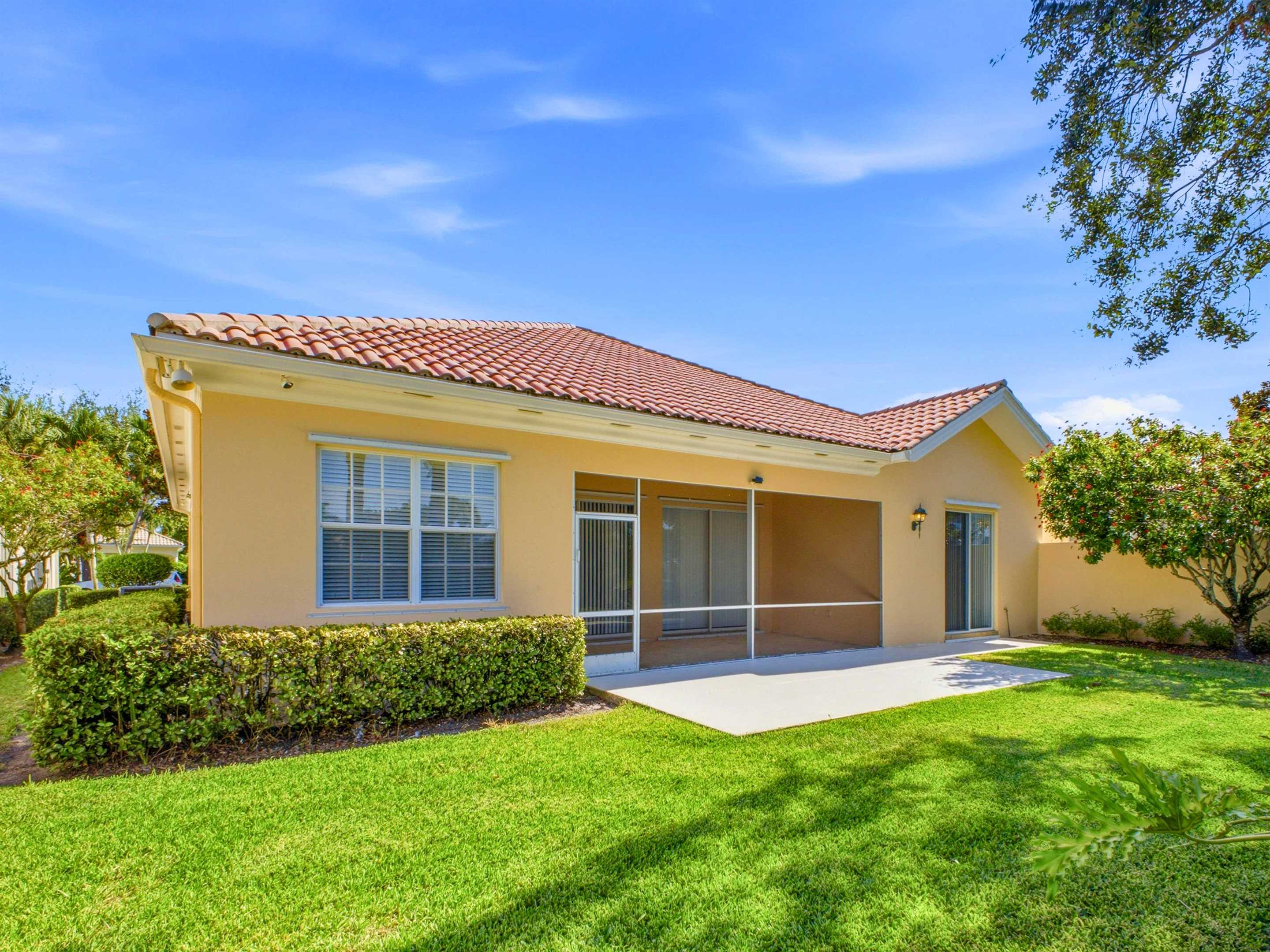 Rear exterior and lakefront setting at 8033 Kaliko Lane